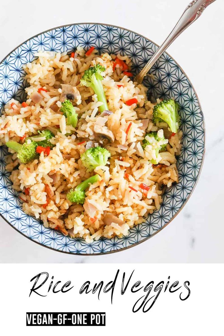 rice and veggies in a blue bowl with a spoon on the side text reads, rice and veggies vegan - be - be - one pot