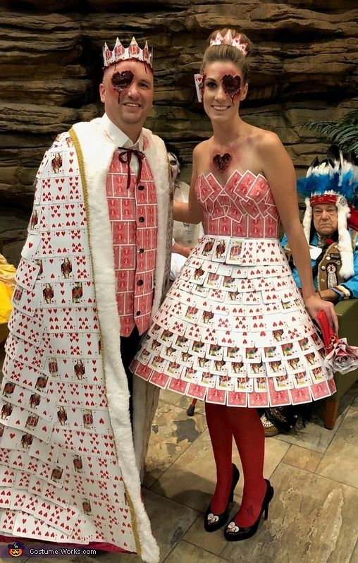 a man and woman dressed in costumes standing next to each other