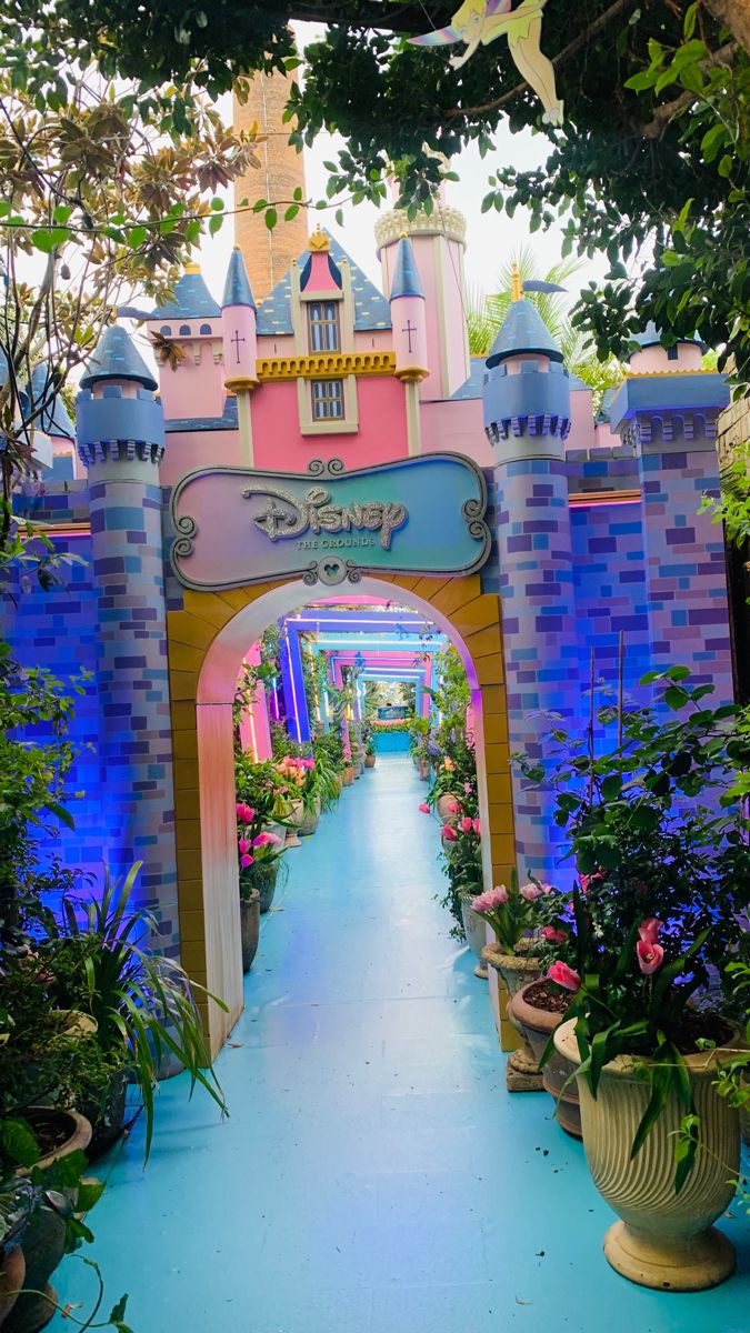 the entrance to disney's fairy land is decorated in pink, blue and yellow