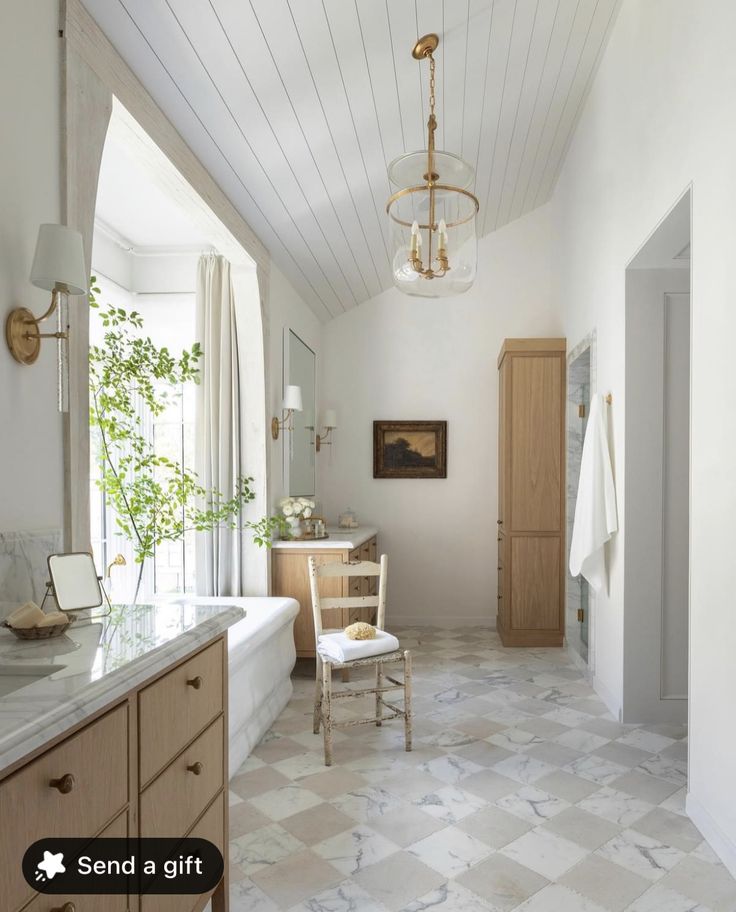 a bathroom with a tub, sink, and mirror in it's center area