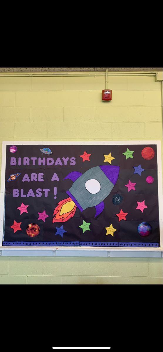 a bulletin board with an image of a rocket ship and the words birthdays are a blast