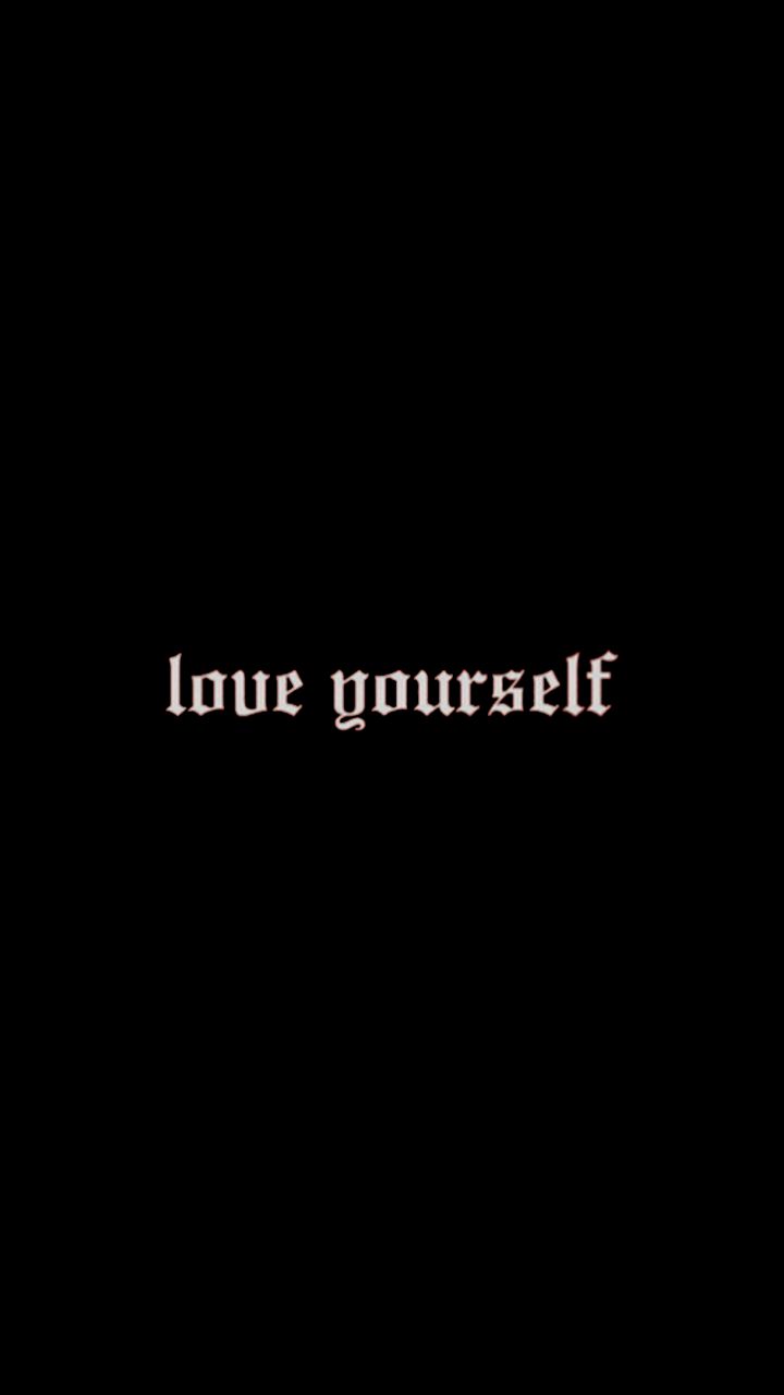 the words love yourself written in white on a black background