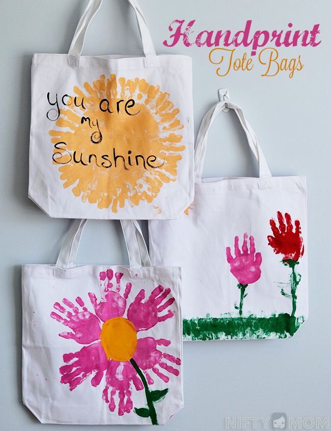 three handprinted bags with flowers and the words you are my sunshine written on them