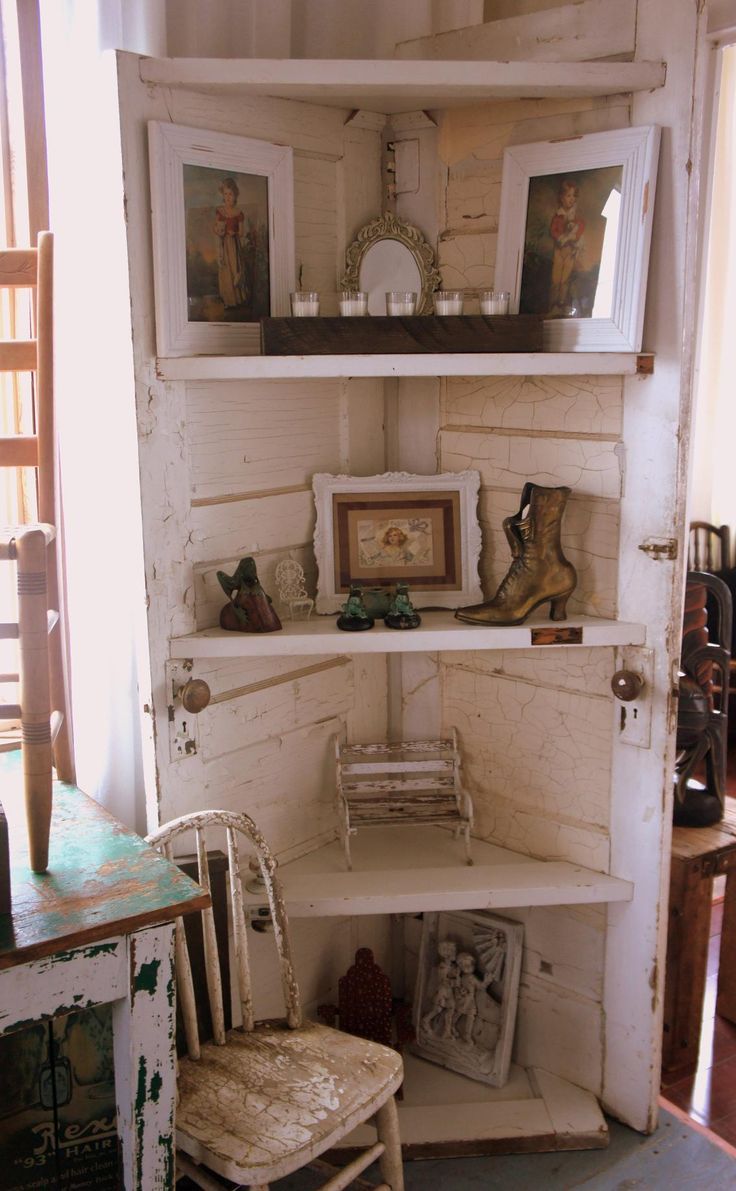 an old book shelf with pictures and other items on it