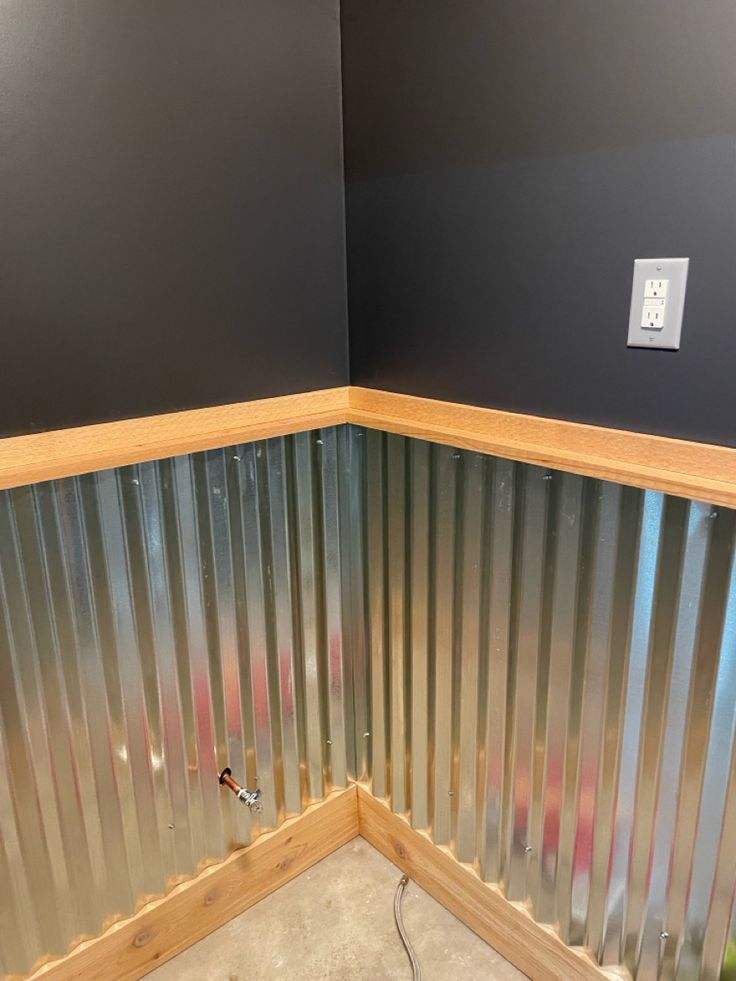 the corner of a room with metal walls