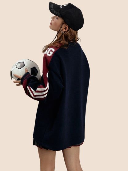 a young woman holding a soccer ball in her right hand and wearing a black hat