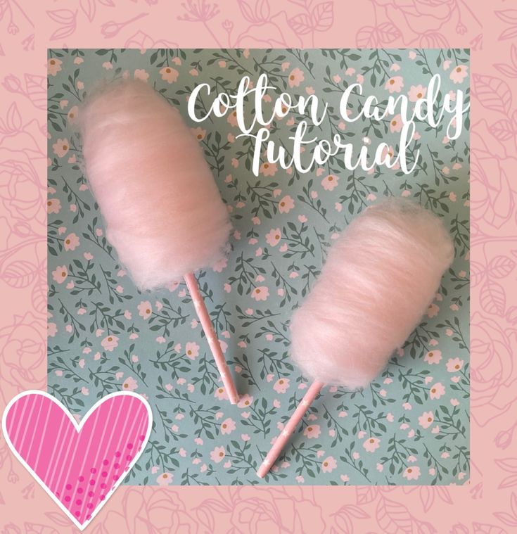 two pink cotton candy lollipops sitting next to each other on a floral background