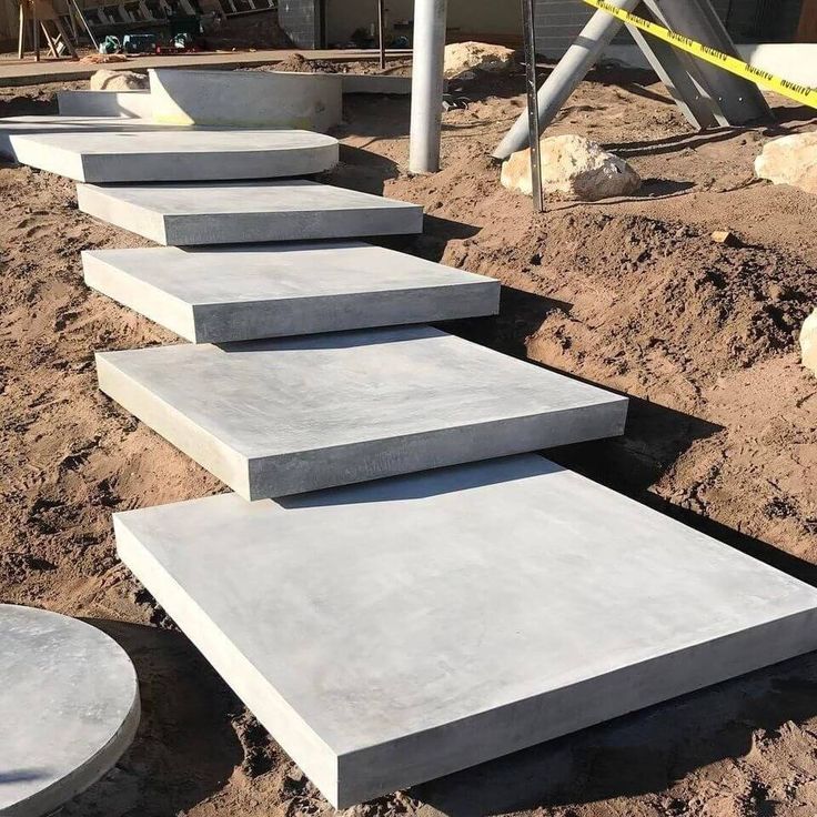 concrete steps are lined up in the dirt