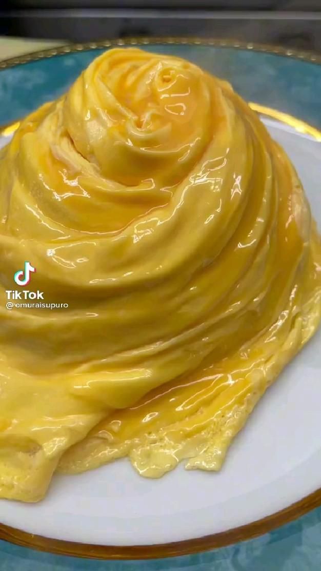 a white plate topped with yellow frosting on top of a table