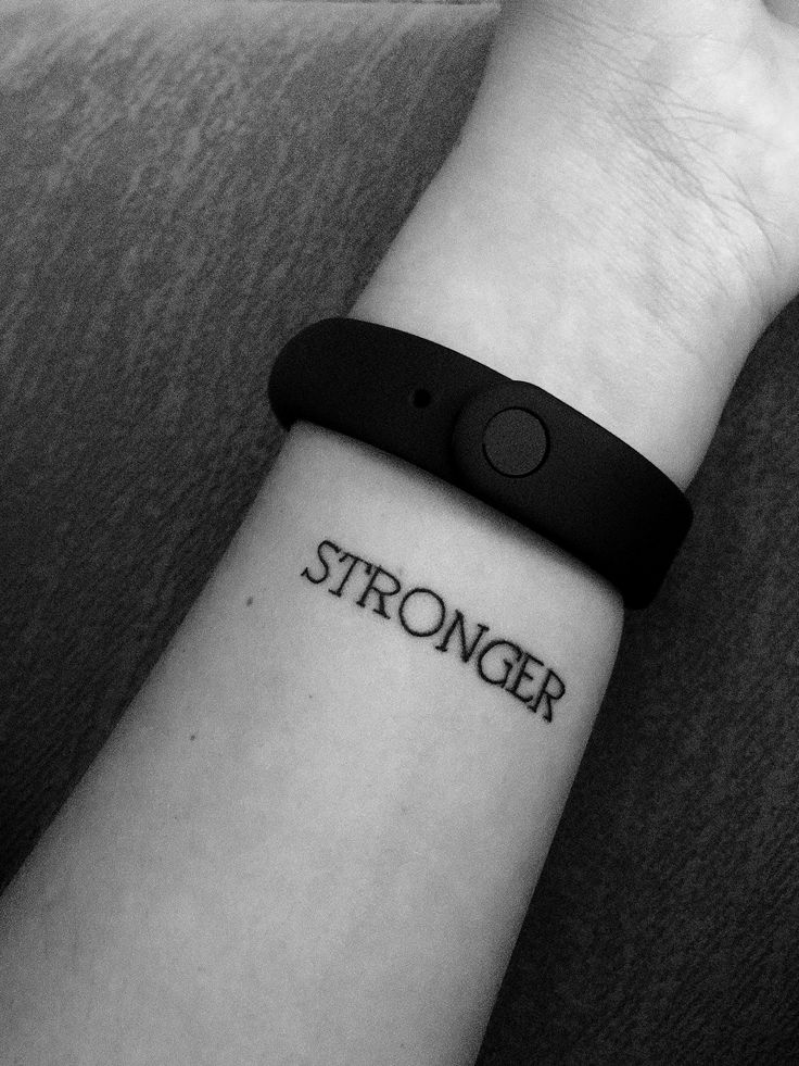 a wrist tattoo with the word'stronger'on it and a rubber band