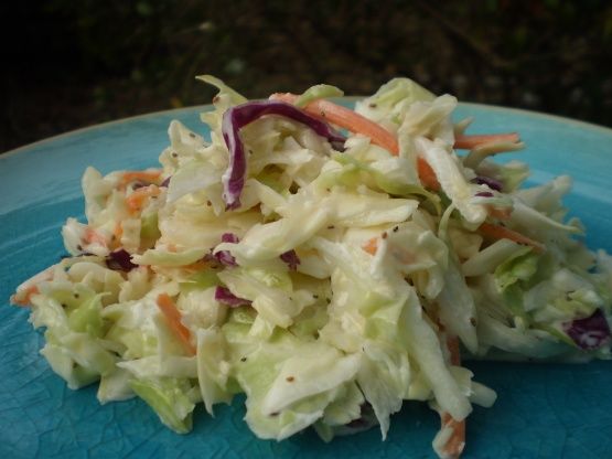 a blue plate topped with coleslaw and carrots