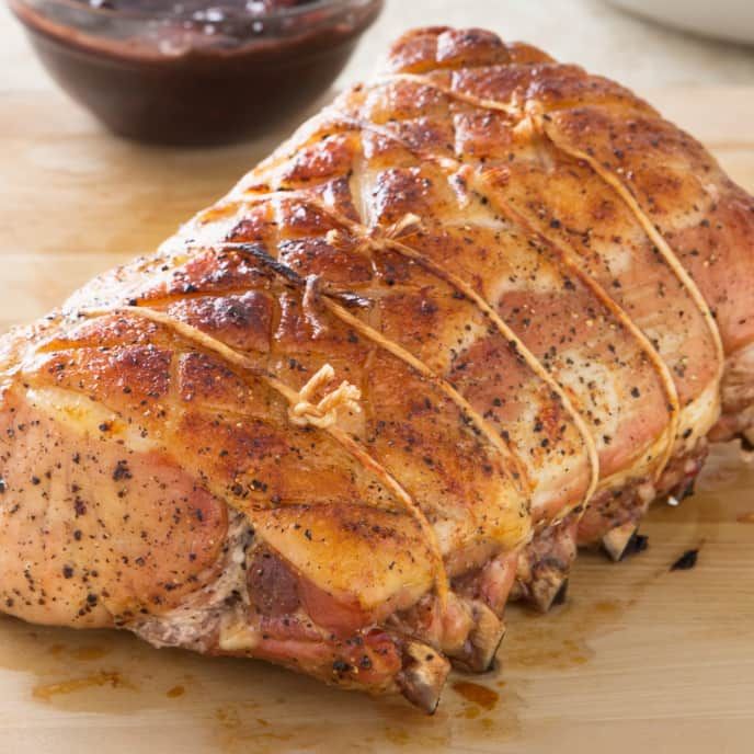 a large piece of meat sitting on top of a wooden cutting board