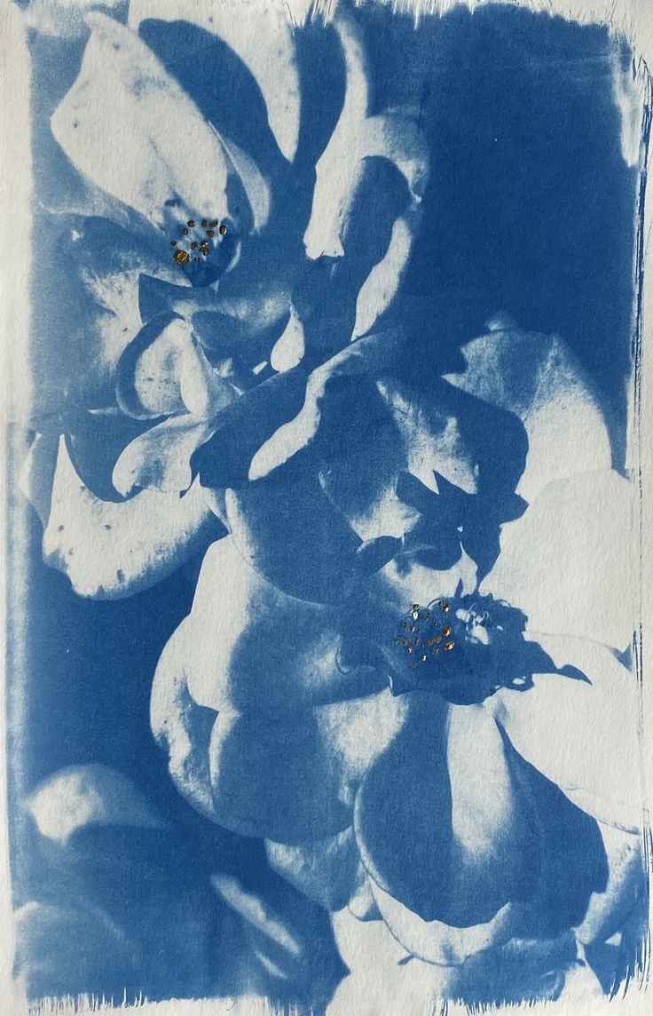 a blue and white painting with flowers on it