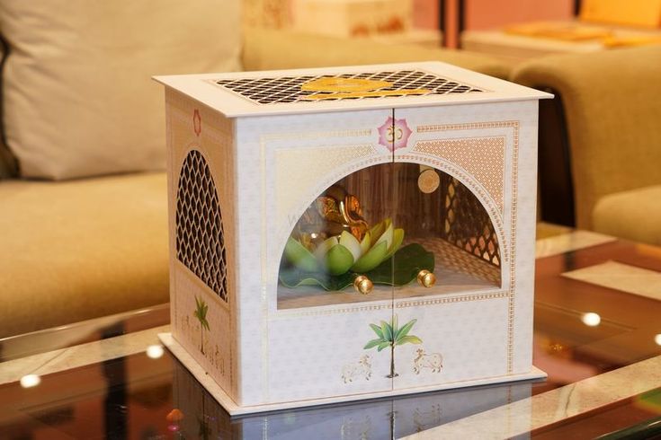 a white box sitting on top of a glass table