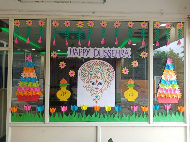 a window decorated with colorful paper flowers and decorations for diwaling on the windowsill