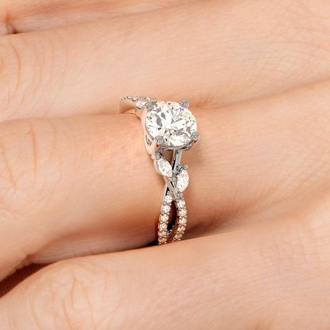 a woman's hand with a diamond ring on top of her finger and an engagement band