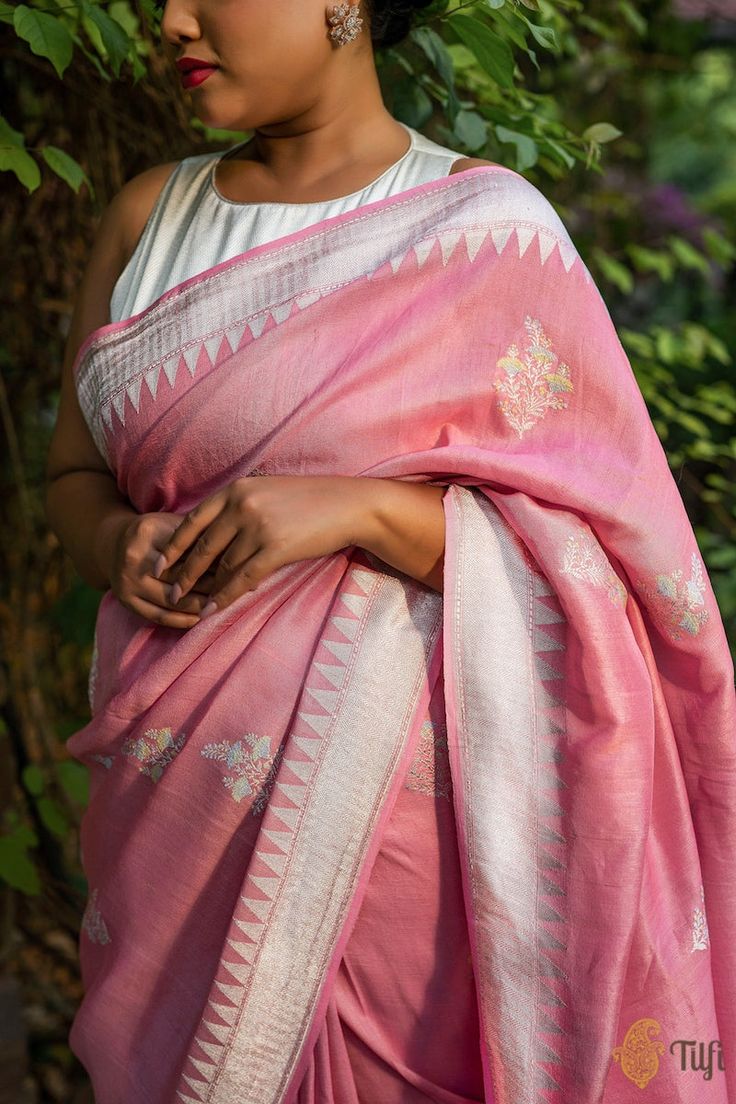 "Woven in the fine weaving techniques\u00a0of Banaras, this charming drape has beautiful bootas with floral design inspirations, Meenakari accents on textured\u00a0silk and shimmering roopa zari.\u00a0\n\n\n\n Color\u00a0- A\u00a0beautiful\u00a0shade of Carnation Pink\n\n Technique\u00a0- An enduring Kadwa weave. This elaborate and laborious technique involves hand-weaving each motif separately. It takes longer on the handloom, but makes a more robust pattern which stands out on the fabric.\n\n Fabric\u00a0- Textured in appearance, pure Tussar by Georgette Silk\u00a0\n\n Speciality\u00a0-  Delicately shimmering silver zari and a dainty pastel palette come together on this marvellous\u00a0blend of pure fabrics. The bootas have been subtly detailed with fine Meenakari work in soft\u00a0colou Carnation Pink, Designer Dresses Indian, Silk Organza, Effortless Elegance, Banarasi Sarees, Handloom Saree, Weaving Techniques, Coral Pink, Blouse Piece