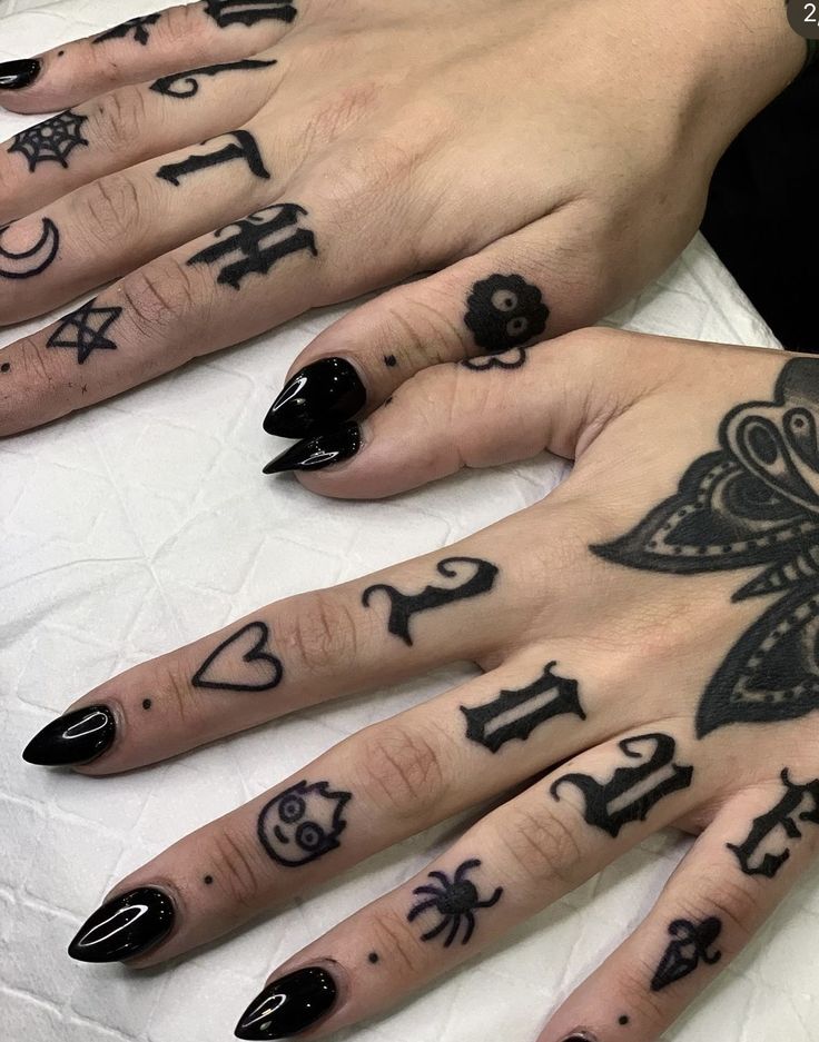 two hands with black and white tattoos on them