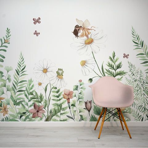 a pink chair sitting in front of a wall mural with flowers and butterflies on it