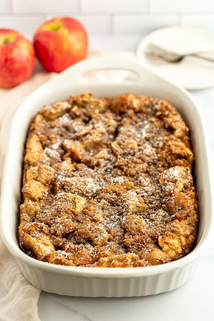 a casserole dish with apples in the background