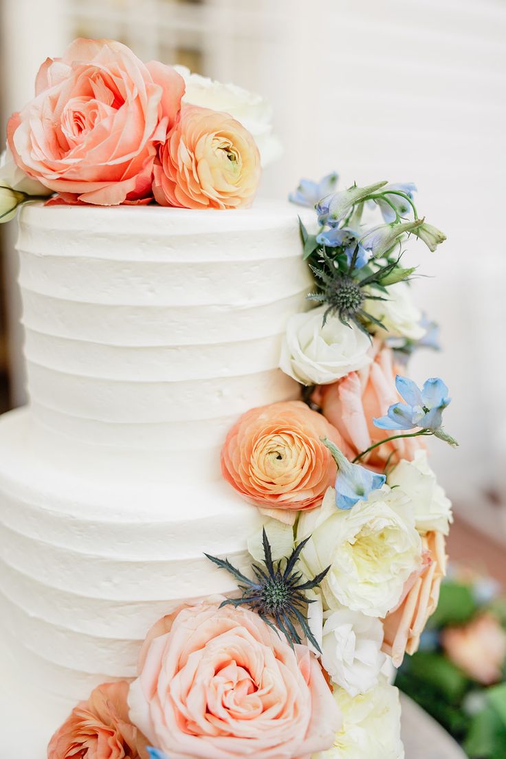 a wedding cake with flowers on it