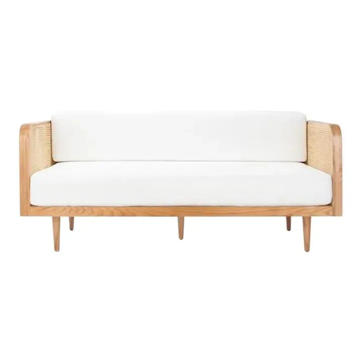 a white couch sitting on top of a wooden frame