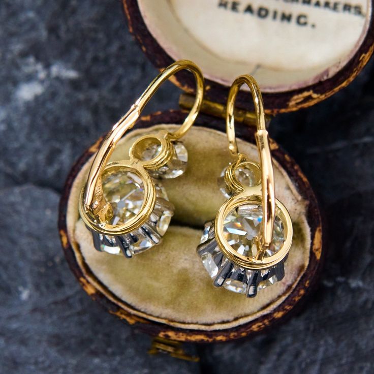 These dazzling platinum topped 18K yellow gold earrings are each accented with one (1) old European cut diamond set into an eight-prong platinum setting and one (1) old European cut diamond set into a four-prong platinum setting. The earrings measure 24.3mm X 10.9mm and are finished with 14K yellow gold lever style backs. They are simply perfect. Yellow Gold Diamond Cut Earrings For Evening, Rose Cut Diamond Earrings In 14k Gold, Evening Yellow Gold Diamond Earrings With Prong Setting, Vintage Yellow Gold Round Diamond Earrings, Victorian Diamond Cut Earrings For Gift, Gold Rose Cut Diamond Earrings, Evening Yellow Gold Earrings With Rose Cut Diamonds, Formal 14k Gold Earrings With Single Cut Diamonds, Vintage Yellow Gold Diamond Earrings For Pierced Ears