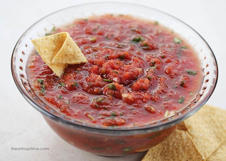 a glass bowl filled with salsa and tortilla chips