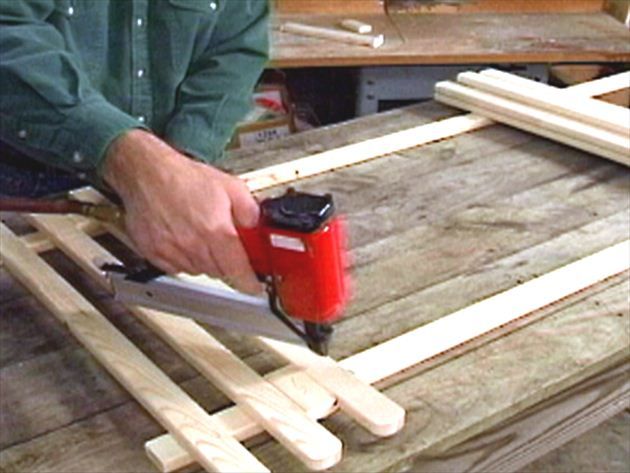 a man using a power drill to cut wood planks with a jig saw