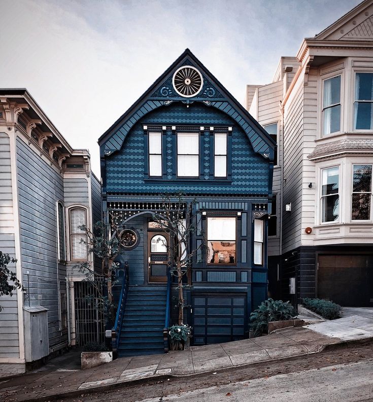 a blue house with a clock on the front