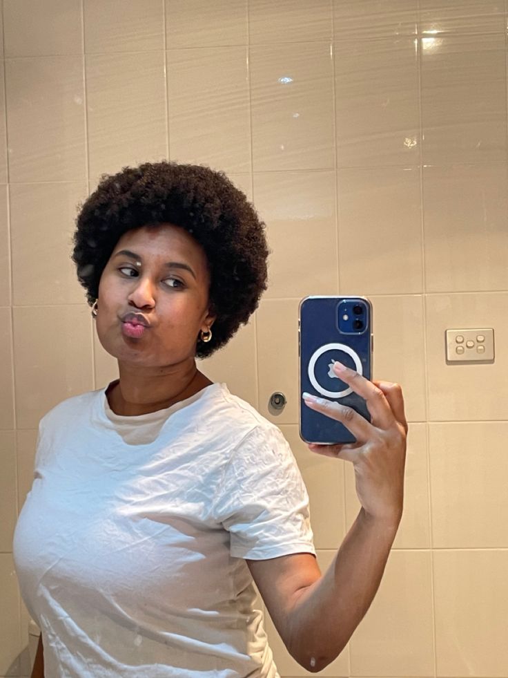 Black girl wearing a white t-shirt posing infront of the mirror for a photo she has an Afro (it’s a mini afro) 4c Small Fro, Mini Afro Aesthetic, Small Afro Hairstyles 4c Hair, Mini Afro Hairstyles 4c, Small Afro Hairstyles Natural, Mini Afro Hairstyles, Short Afros, Short Hair 4c, Short 4b Hair