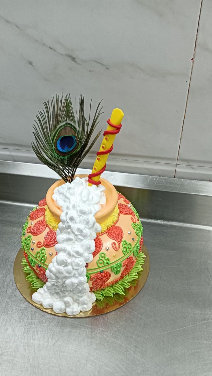 a decorated cake with a peacock on top and feathers sticking out of it's back