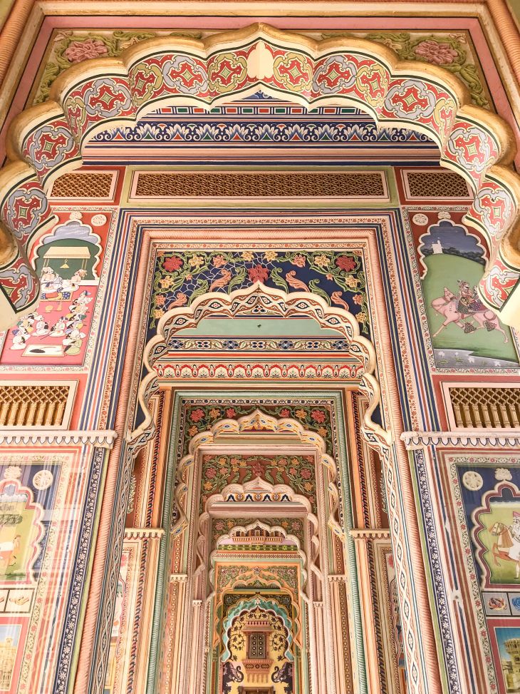 an intricately decorated archway in the middle of a building with colorful paintings on it