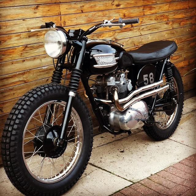 a motorcycle parked next to a wooden wall