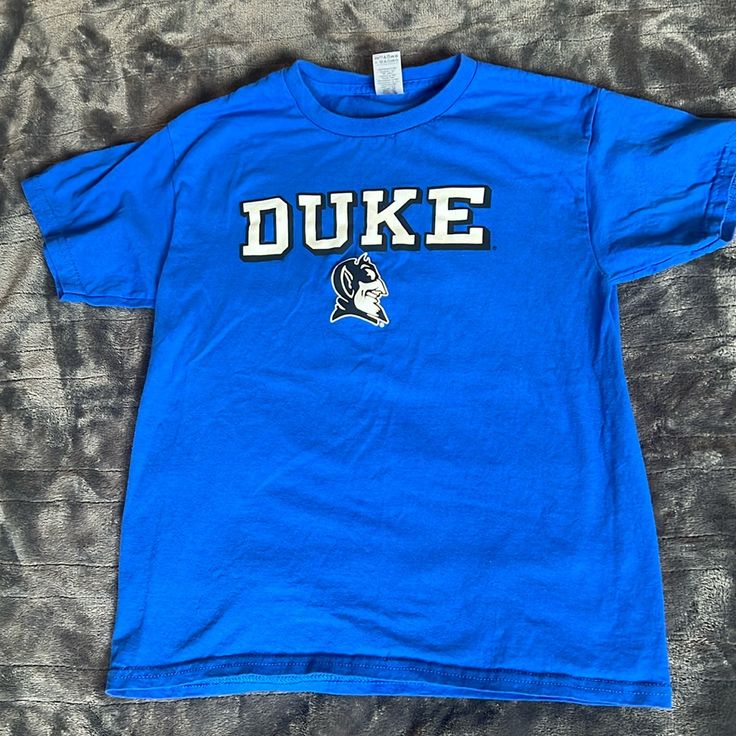 Washed In The Washing Machine And Dried But Then Never Worn. Looks Brand New. Duke University Children’s Medium Shirt. In My Opinion, This Would Fit A 10-Year-Old. Although My 10-Year-Old Never Ended Up Wearing It. Blue T-shirt For School Spirit Fan Merchandise, Blue School Spirit T-shirt With Text Print, Blue Short Sleeve School Shirt, Blue Cotton T-shirt With School Spirit, Blue Cotton T-shirt For School Spirit, Blue Letter Print Top For School, Blue Letter Print Tops For School, Basic Blue School Tops, Basic Blue Tops For School