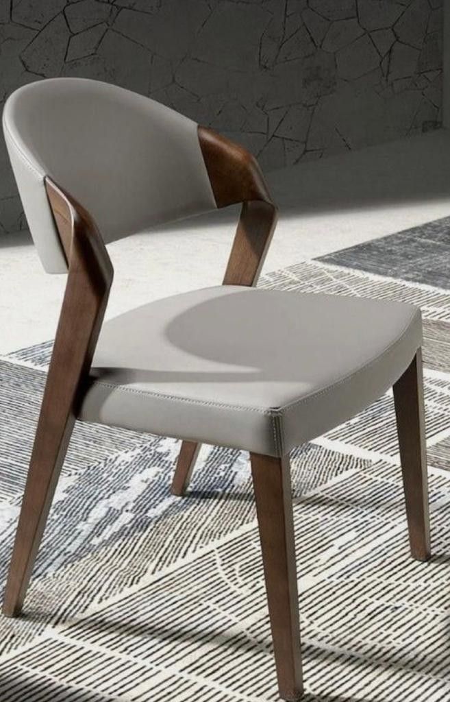 a white chair sitting on top of a rug next to a wooden frame and seat