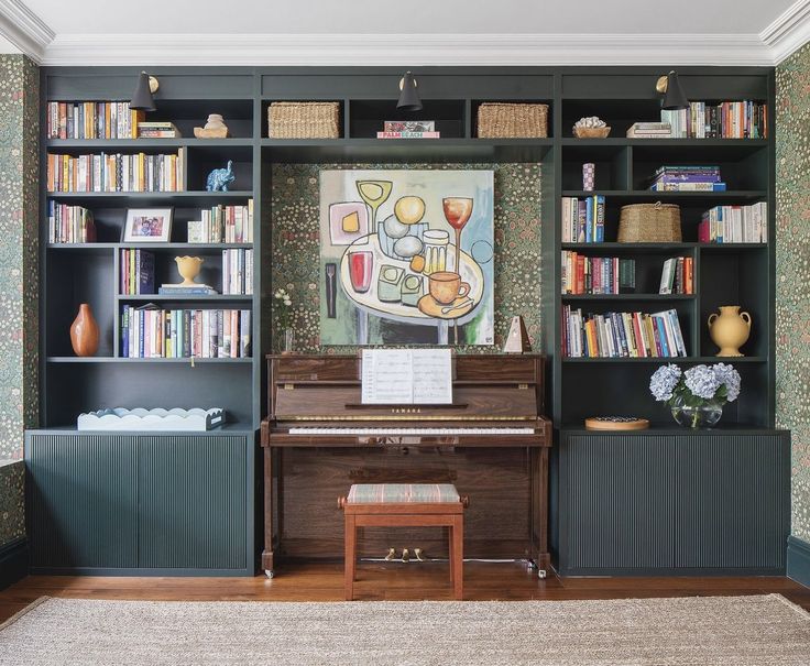 a living room with a piano and bookshelves