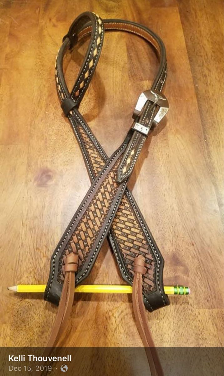 a pair of leather stirs with braiding on them sitting on top of a wooden floor