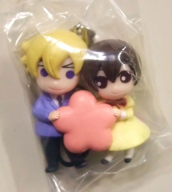 two figurines sitting on top of a plastic bag