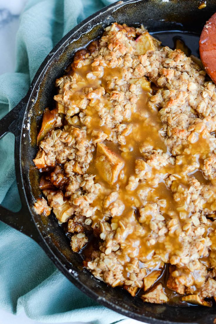 a skillet filled with food sitting on top of a blue towel