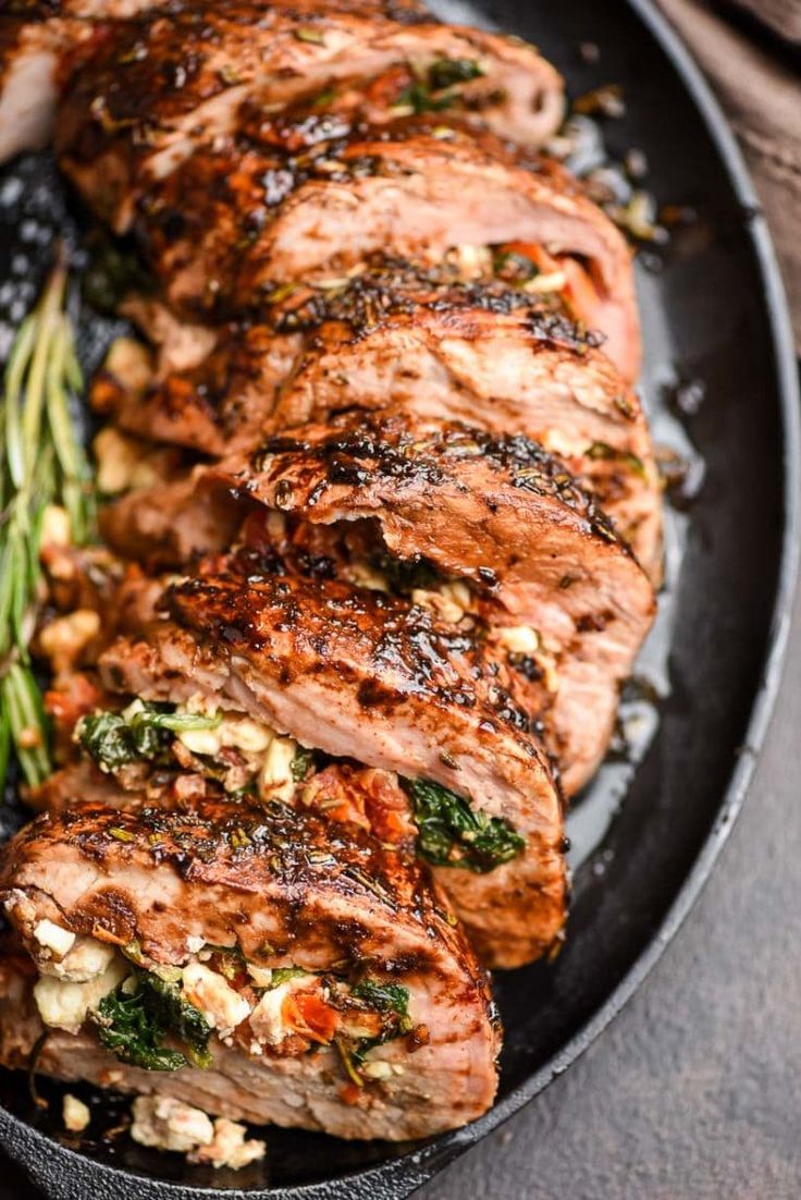 grilled pork chops and asparagus on a black plate