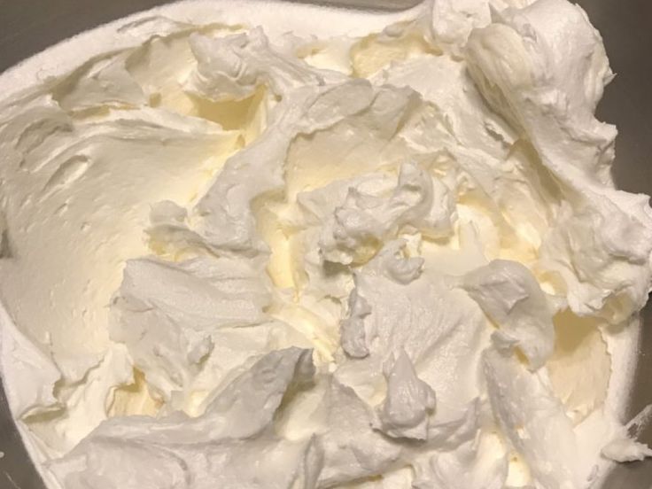 a bowl filled with whipped cream sitting on top of a counter