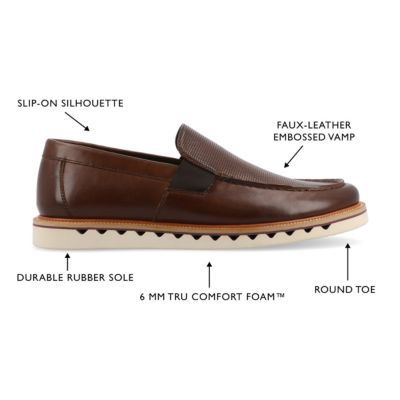 The Dallas loafer from Vance Co. blends sophistication and comfort with its 1-inch heel, slip-on design, and classic round toe. Crafted from faux leather this style offers a stylish alternative. The mesh lining, 6 mm Tru Comfort Foam footbed, and rubber outer sole ensure breathability and cushioned support, making the Dallas loafer a trendy and comfortable choice for various occasions. | Vance Co Men's Dallas Casual, Brown, 8M Synthetic Moc Toe Slip-ons With Rubber Sole, Wingtip Slip-ons With Removable Insole, Synthetic Slip-on Loafers With Leather Sole, Cushioned Wingtip Slip-on Loafers, Semi-formal Slip-ons With Rubber Sole, Brown Synthetic Loafers For Business Casual, Business Casual Synthetic Plain Toe Loafers, Business Synthetic Slip-on Moccasins, Modern Business Moc Toe Slip-ons