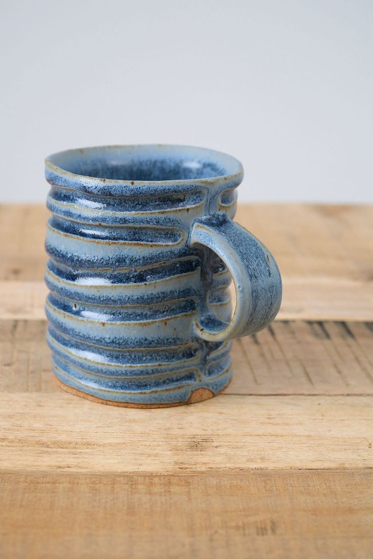 a stack of blue cups sitting on top of a wooden table