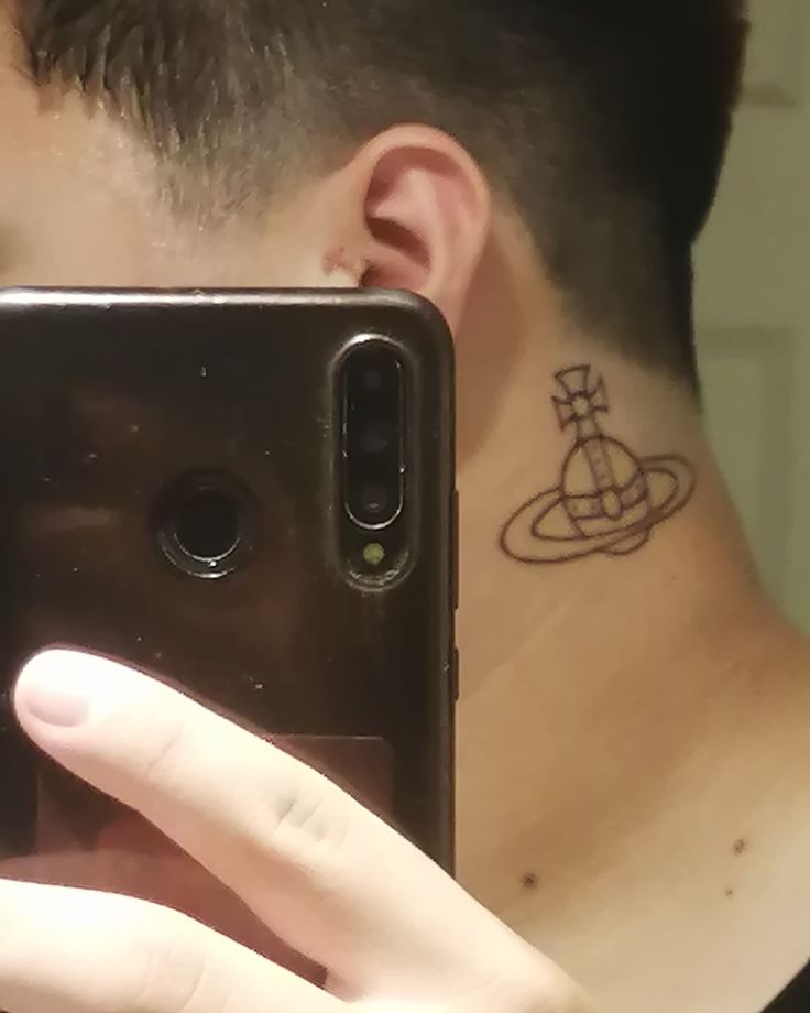 a man with a tattoo on his neck taking a selfie in front of a mirror