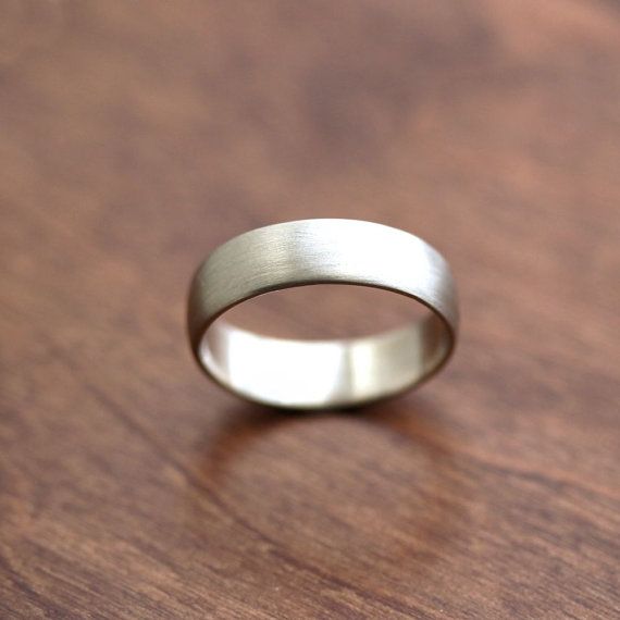 a silver ring sitting on top of a wooden table