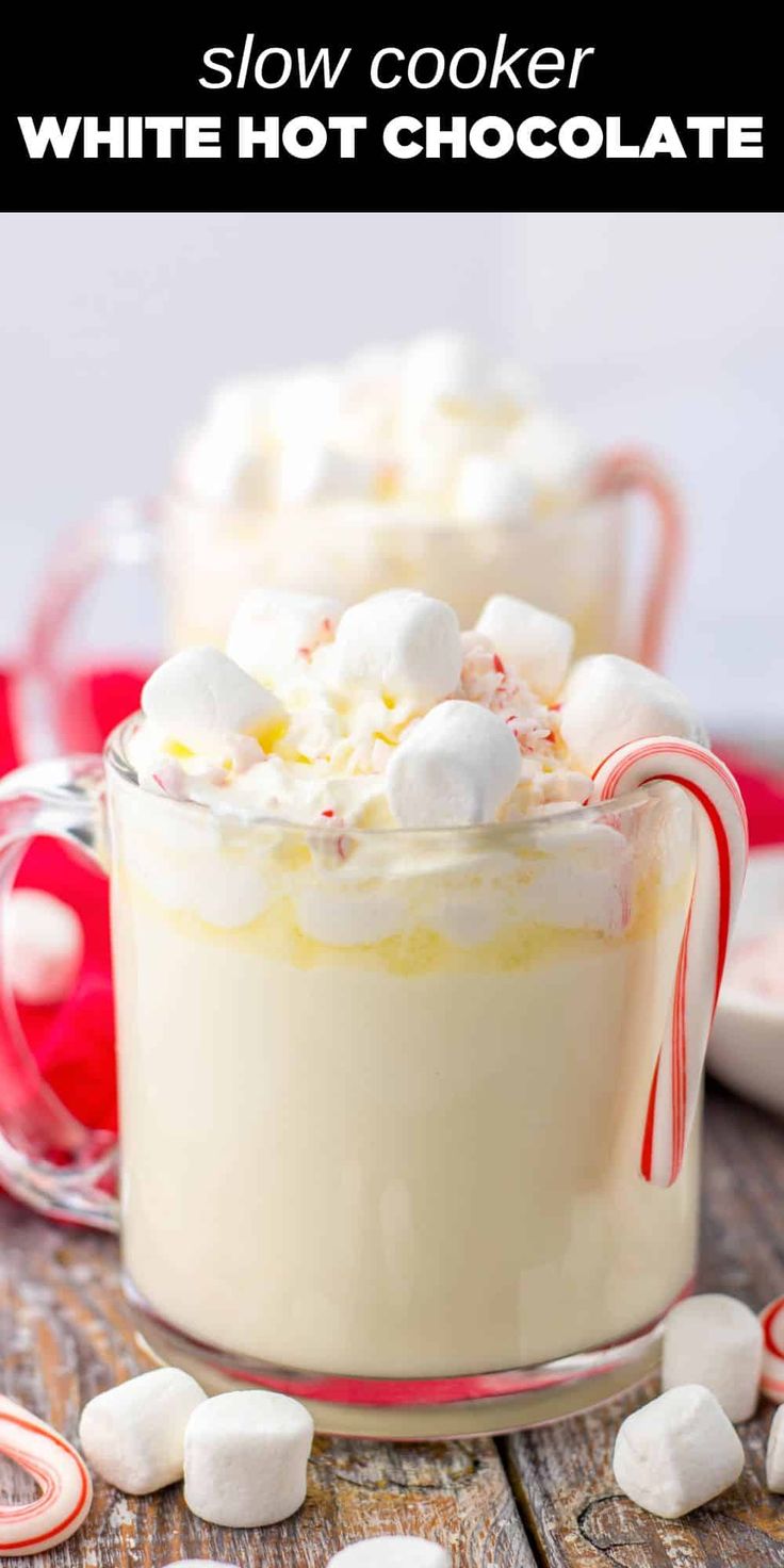 two glasses filled with white hot chocolate and marshmallows