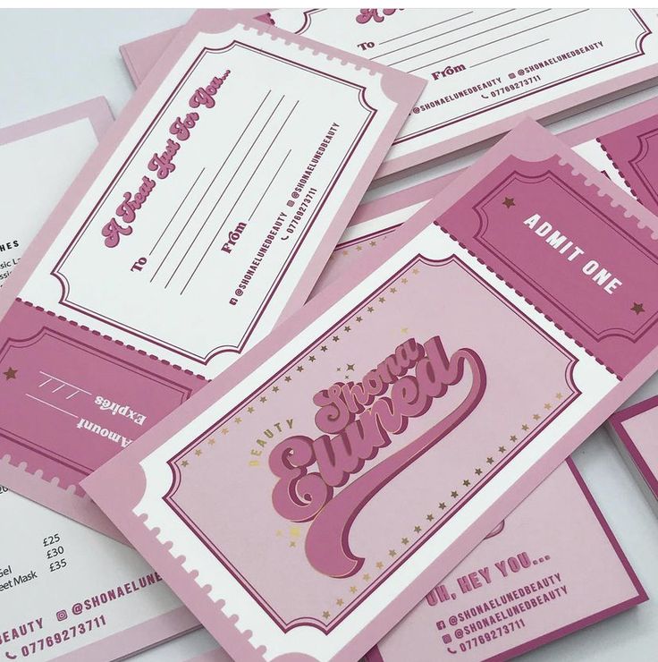 some pink and white business cards with the word happy birthday written on one of them