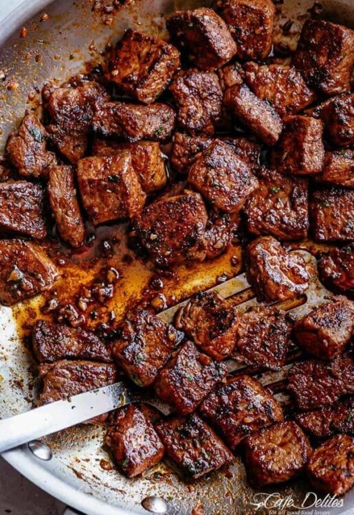 some meat is being cooked in a pan