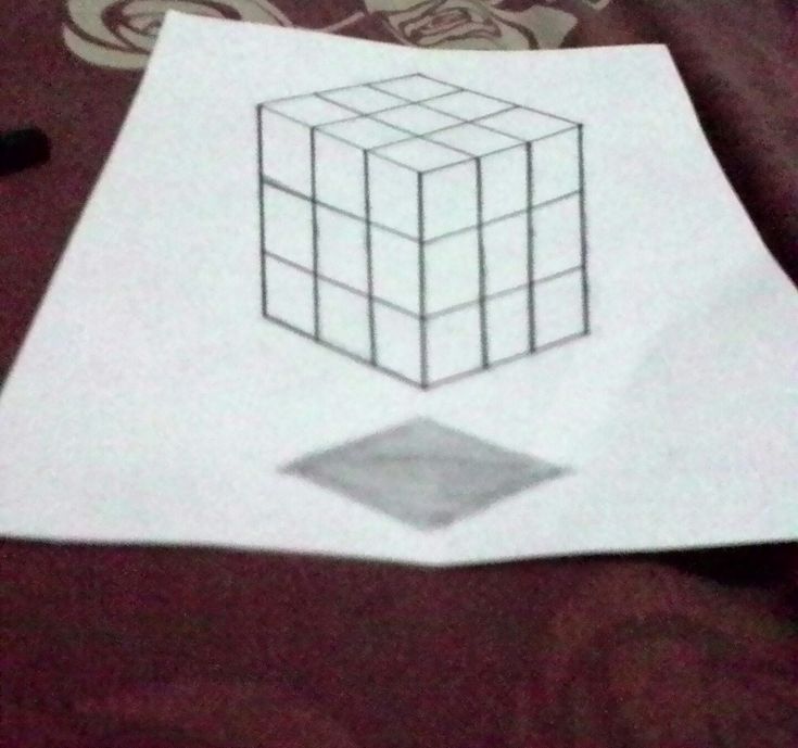 a piece of paper with a drawing of a cube on it